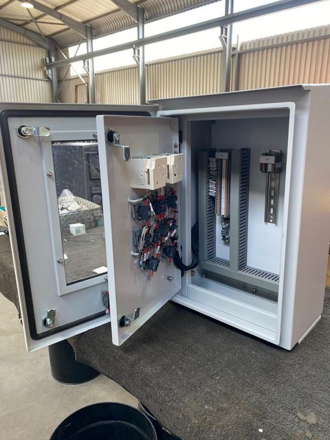 Open grey control panel with internal components